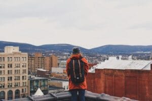 man on rooftop in city