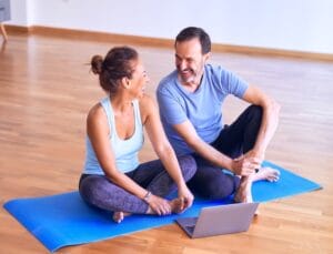 couple sitting on yoga mat