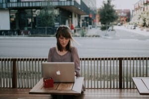 woman working on laptop at a cafe