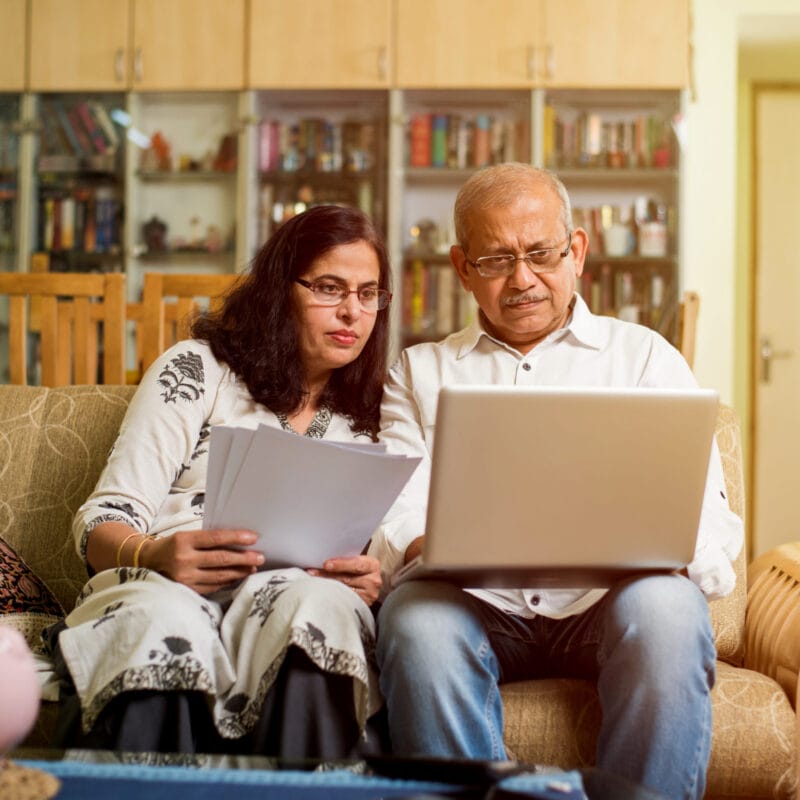 elderly couple on couch reviewing documents CMS compliant provider directory