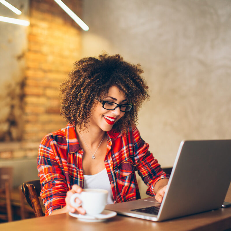 woman on computer with coffee searching for healthcare cost price transparency